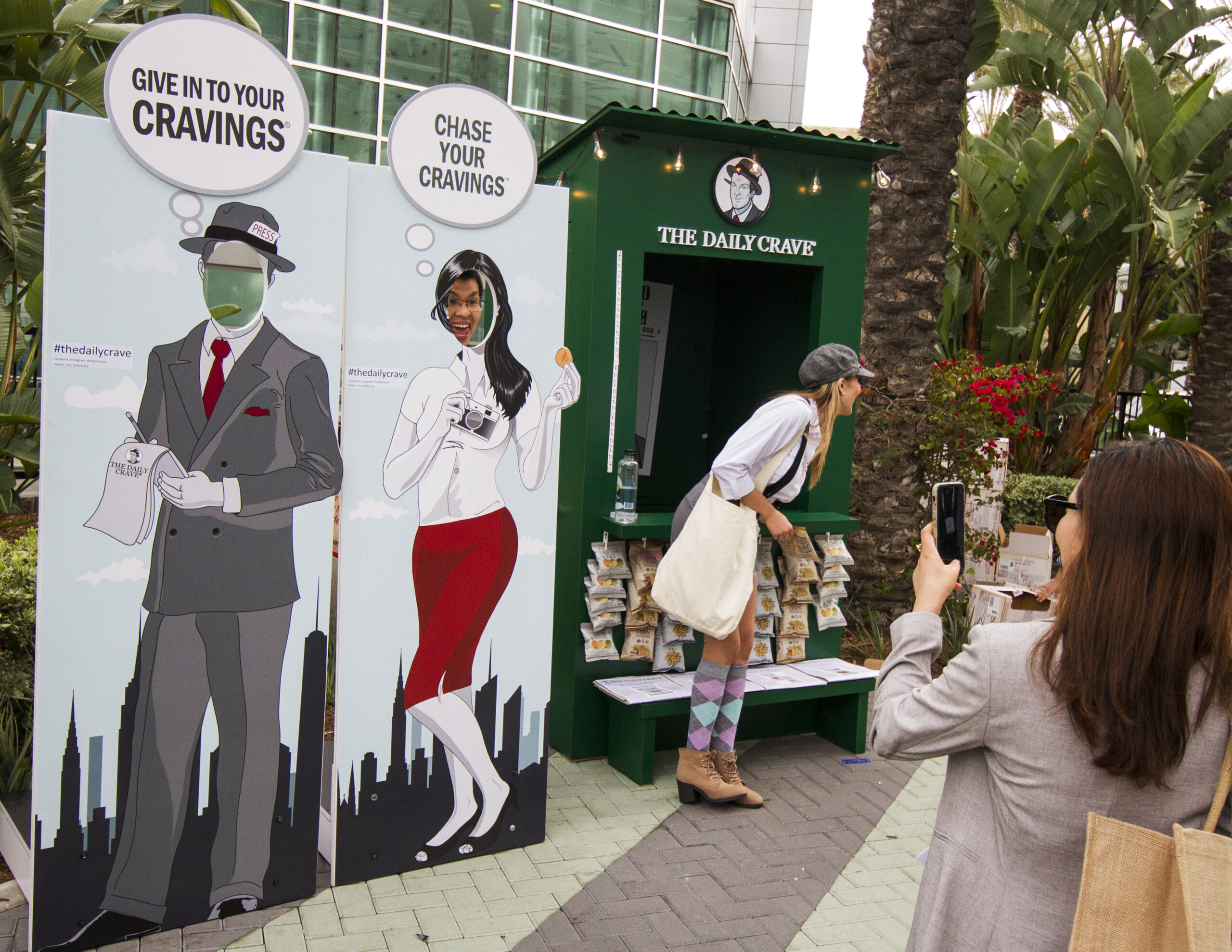 Customer Photographing The Daily Crave Self-Contained Exhibit Outside the Natural Products Expo West